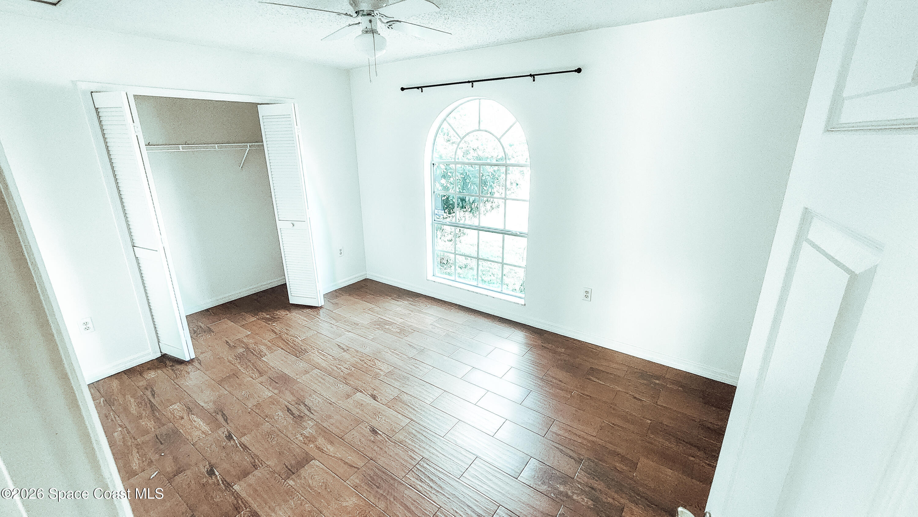 1521 Barber Street Sebastian, FL 32958 - Photo 18 of 33 an empty room with wooden floor and windows