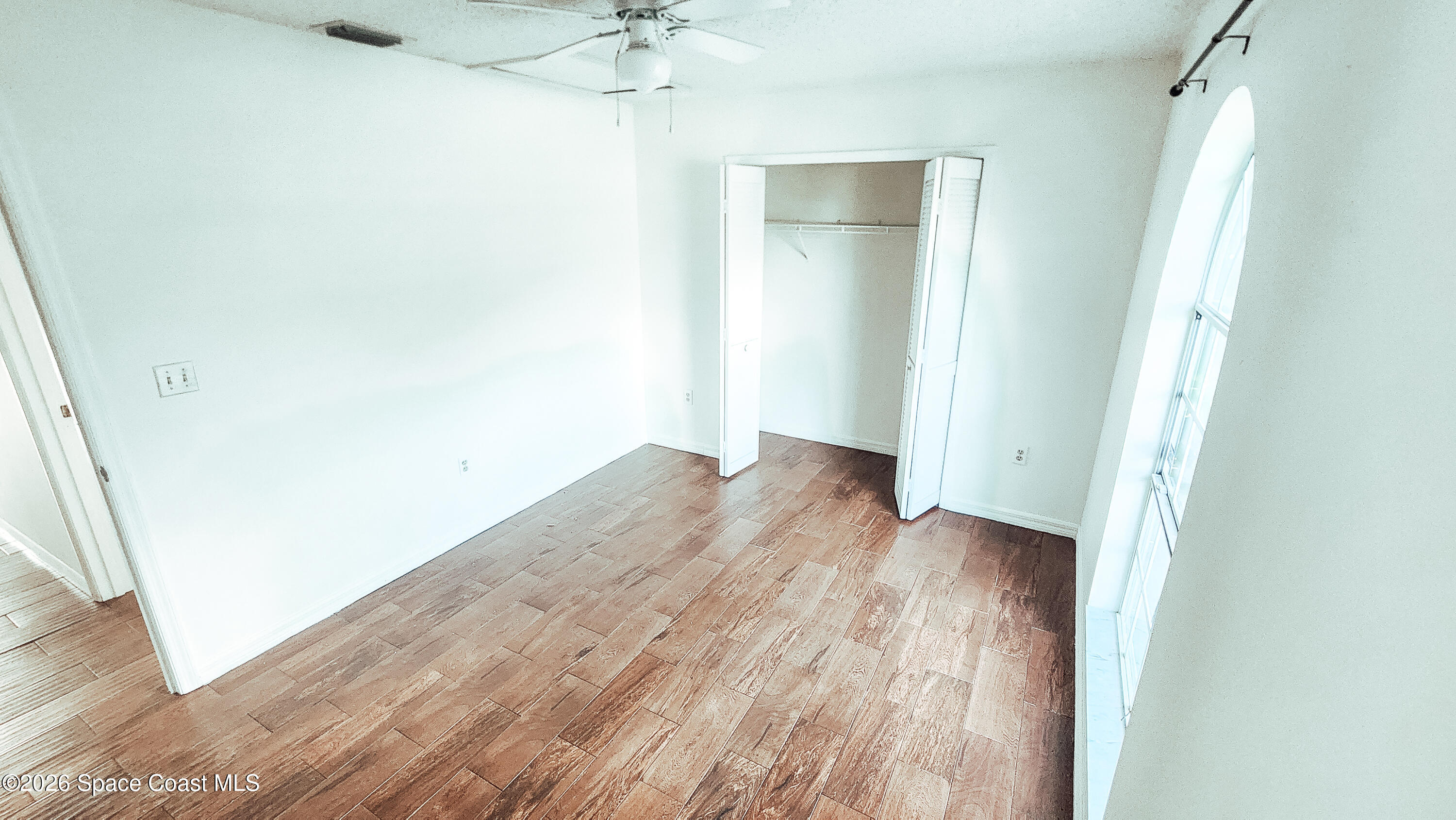 1521 Barber Street Sebastian, FL 32958 - Photo 19 of 33 an empty room with wooden floor and entrance