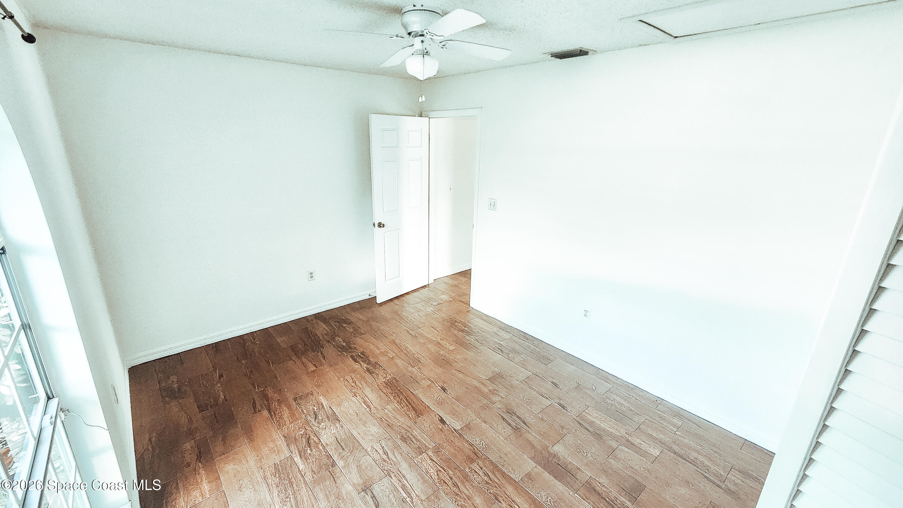 1521 Barber Street Sebastian, FL 32958 - Photo 20 of 33 an empty room with wooden floor and fan