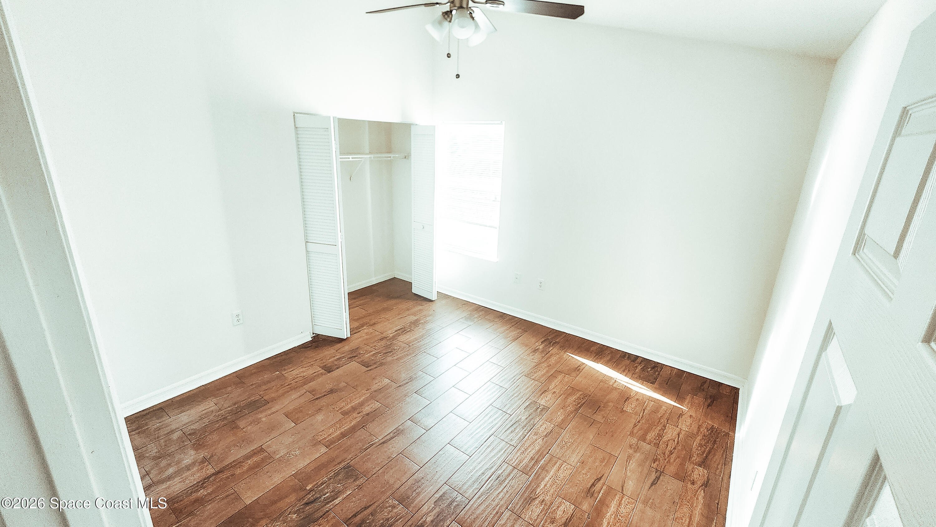 1521 Barber Street Sebastian, FL 32958 - Photo 21 of 33 a view of room with window and wooden floor