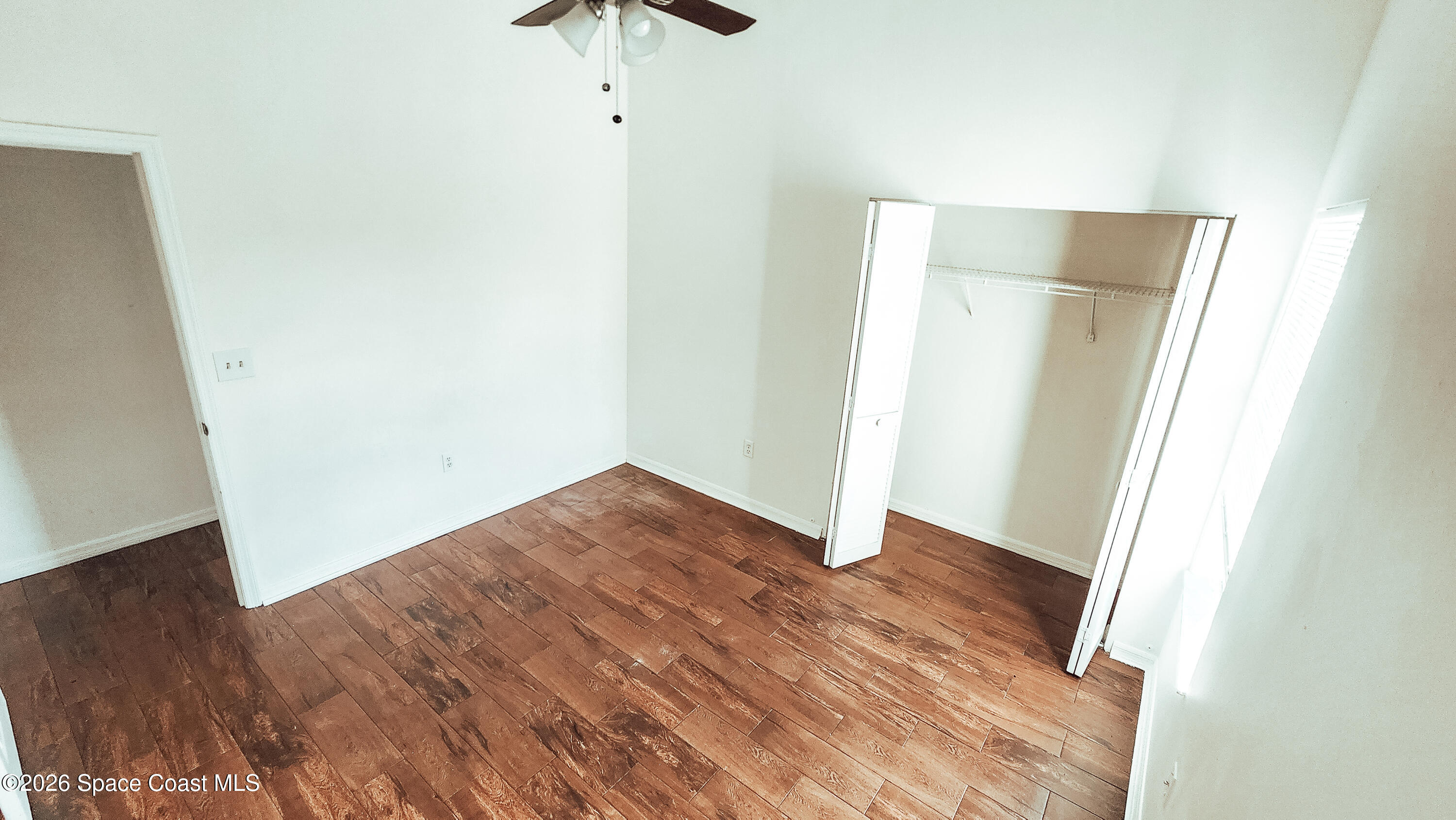 1521 Barber Street Sebastian, FL 32958 - Photo 22 of 33 an empty room with wooden floor and closet