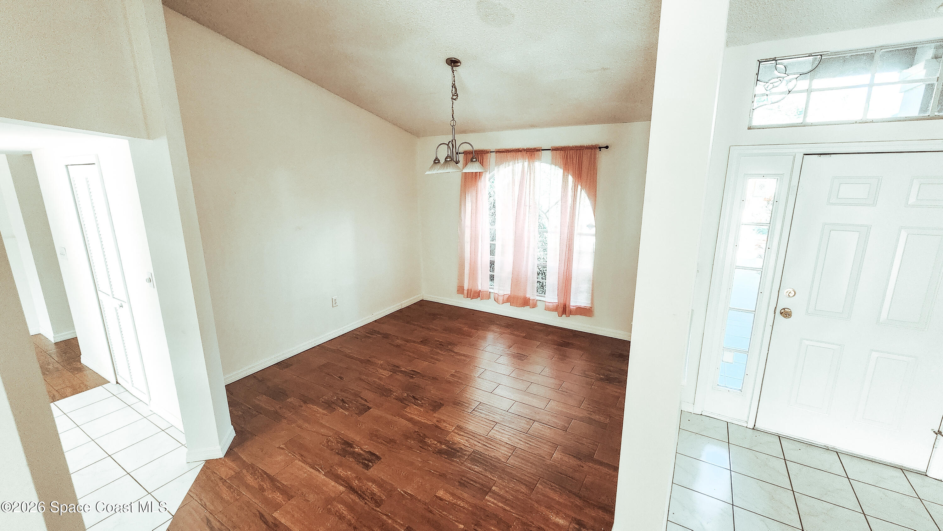 1521 Barber Street Sebastian, FL 32958 - Photo 24 of 33 a view of a room with wooden floor and windows
