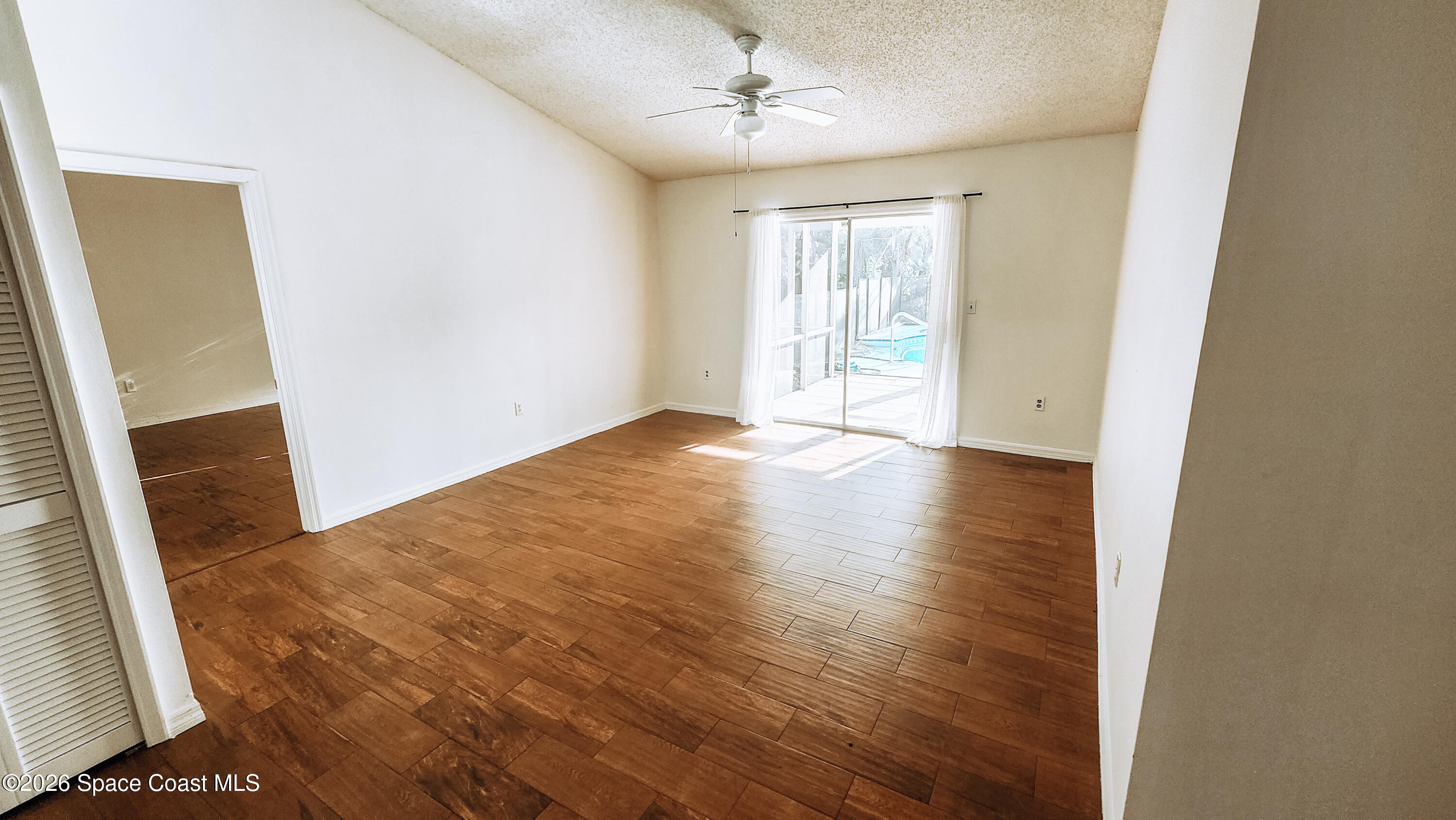 1521 Barber Street Sebastian, FL 32958 - Photo 25 of 33 an empty room with wooden floor and windows