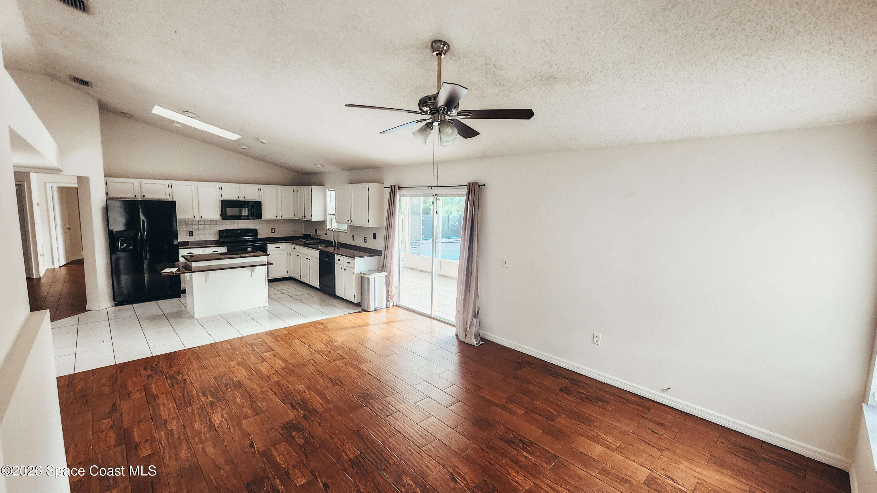 1521 Barber Street Sebastian, FL 32958 - Photo 10 of 33 a view of a kitchen with microwave and refrigerator