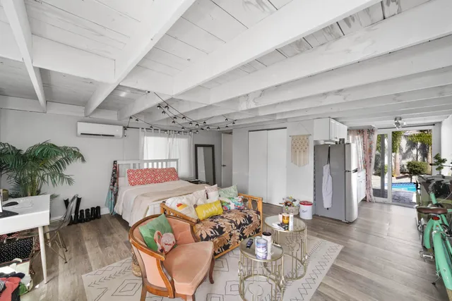 a bedroom with furniture and a chandelier