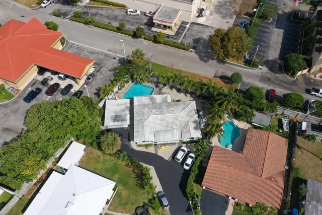 an aerial view of a house with a yard and pool