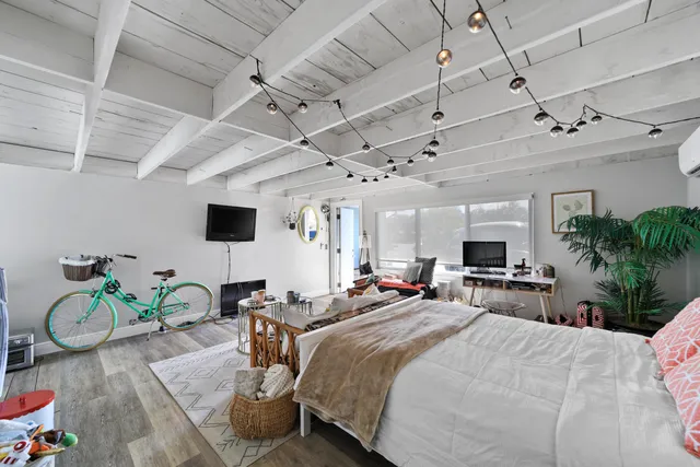 a bedroom with a bed and a flat screen tv