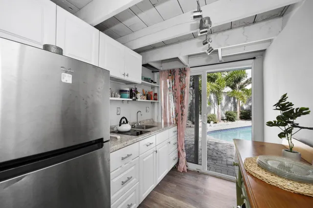 a kitchen with stainless steel appliances granite countertop a sink a stove and refrigerator