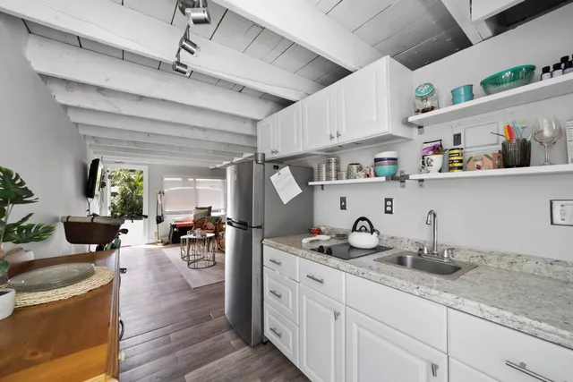 a kitchen with sink a stove and cabinets