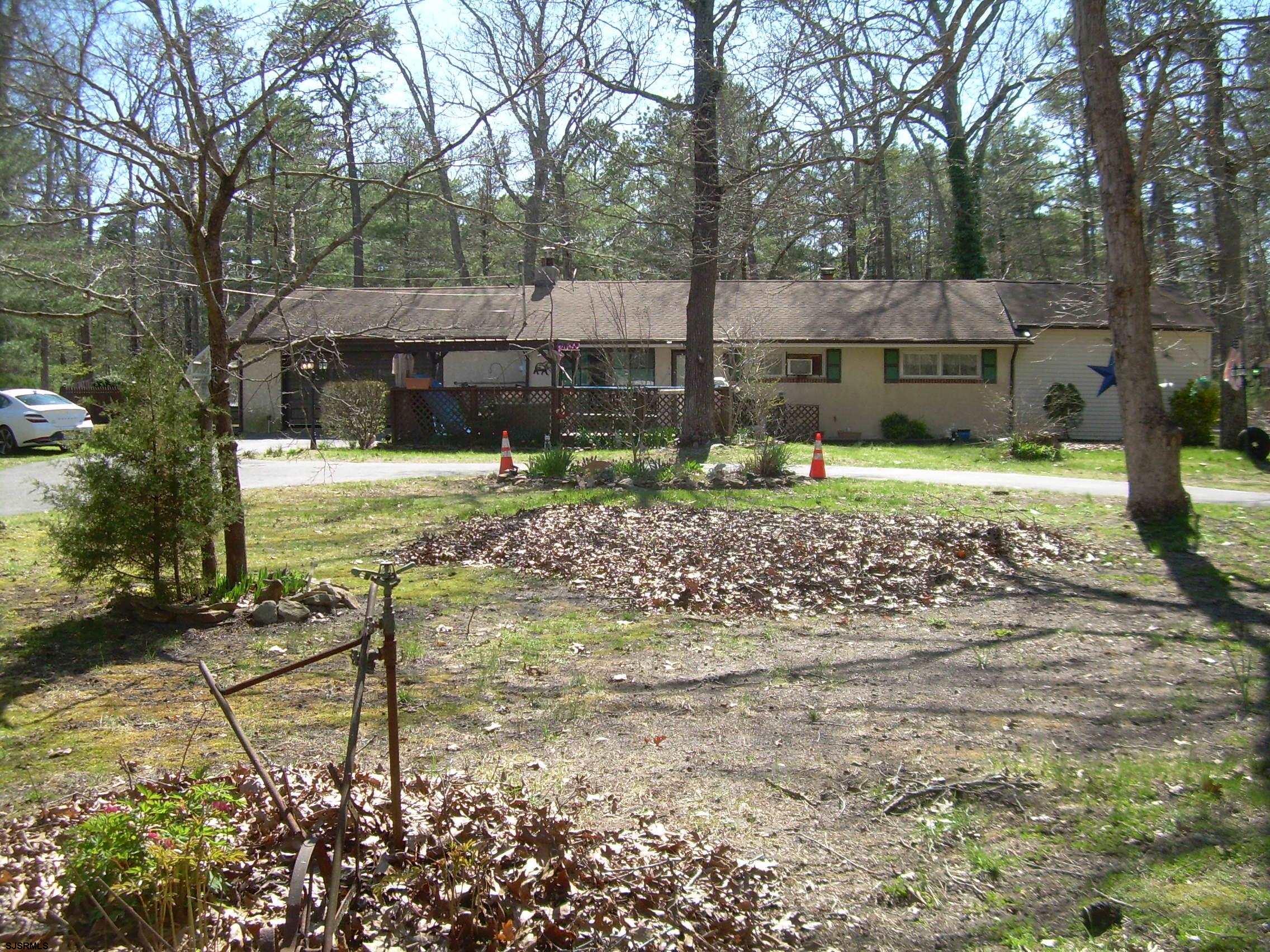a backyard of a house with barbeque oven