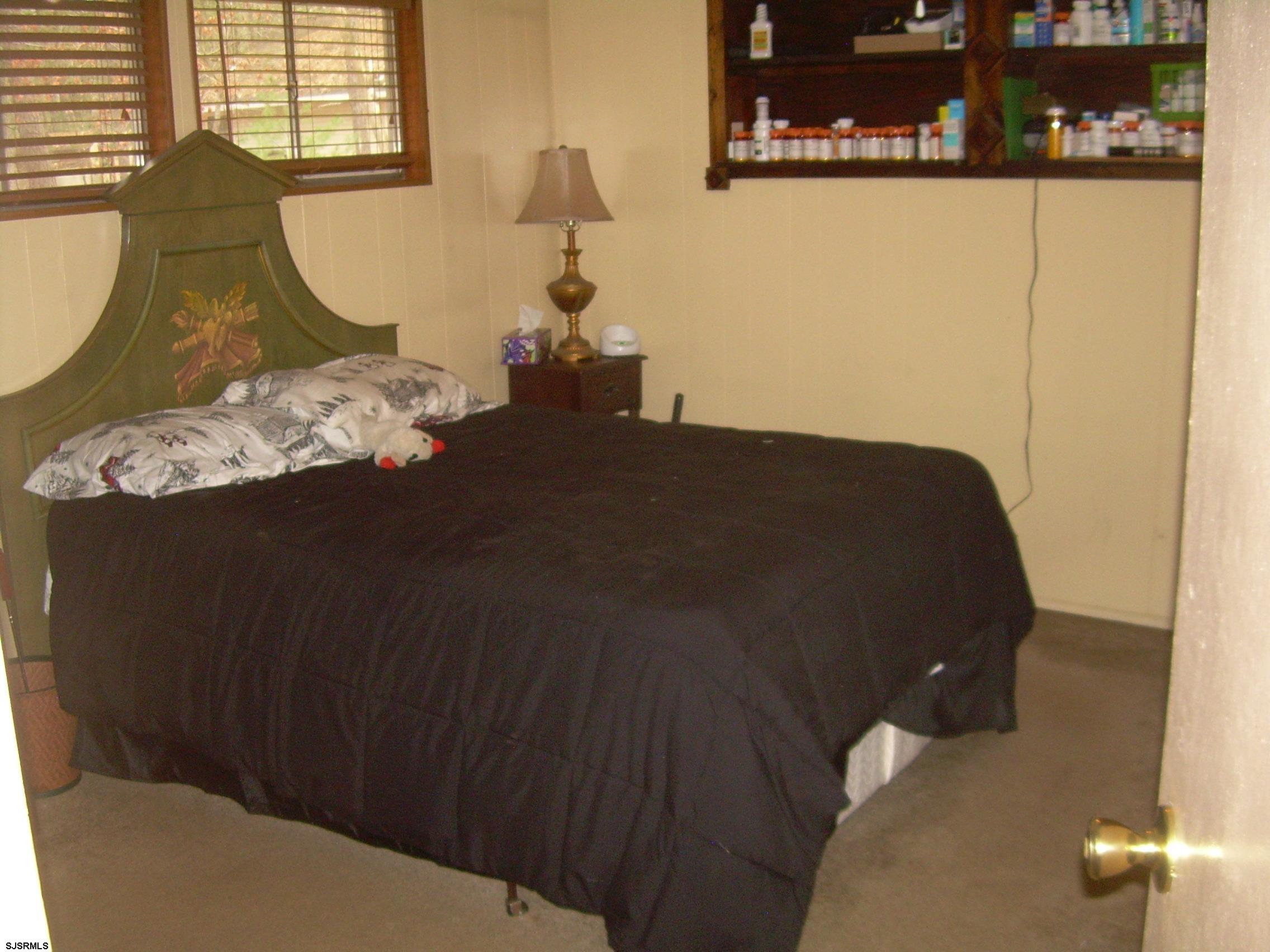 5257 Pleasant Mills Road Hammonton, NJ 08037 - Photo 15 of 27 a bed sitting in a bedroom next to a window