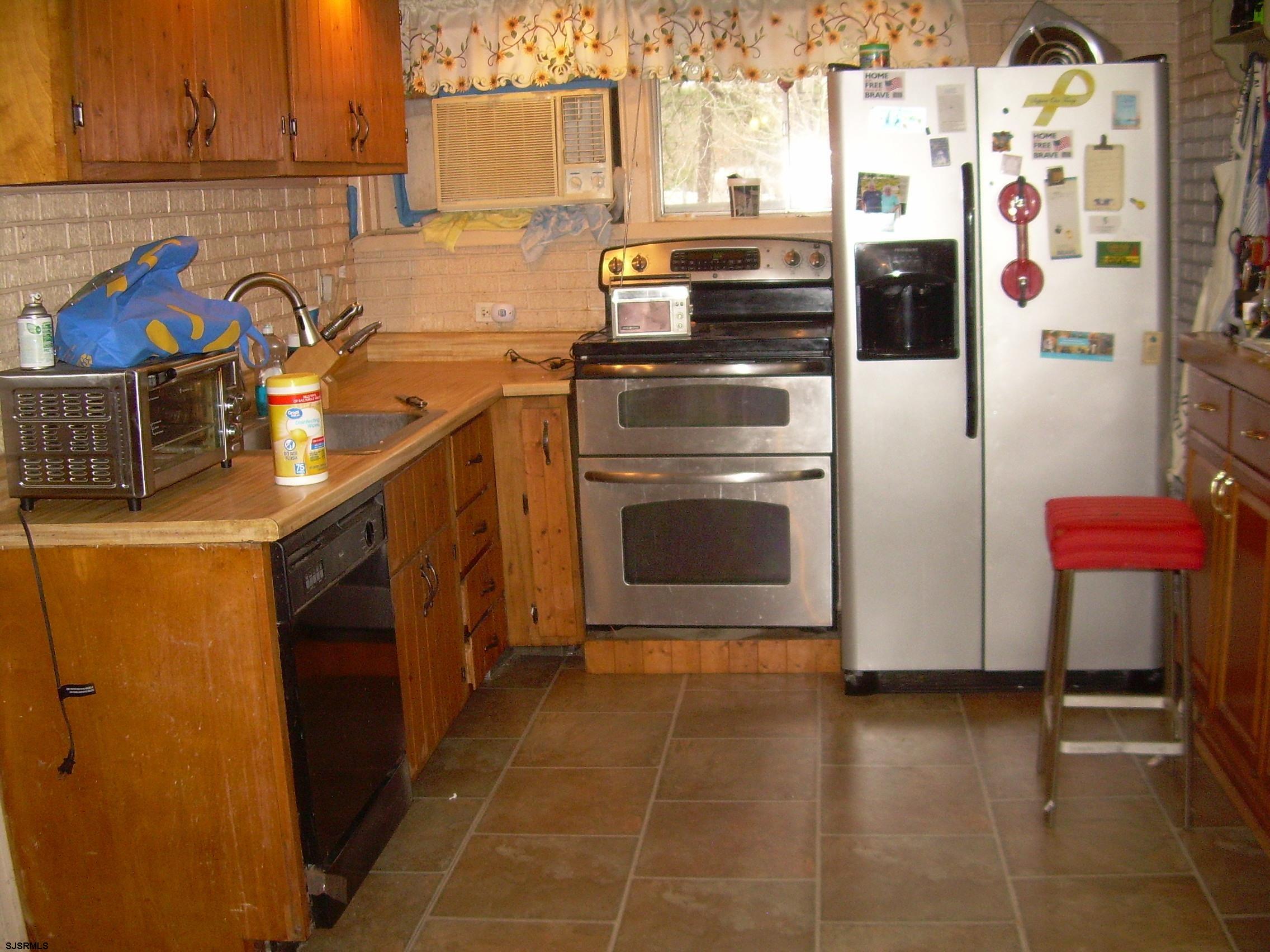 5257 Pleasant Mills Road Hammonton, NJ 08037 - Photo 10 of 27 a kitchen with stainless steel appliances granite countertop a refrigerator a stove and a sink