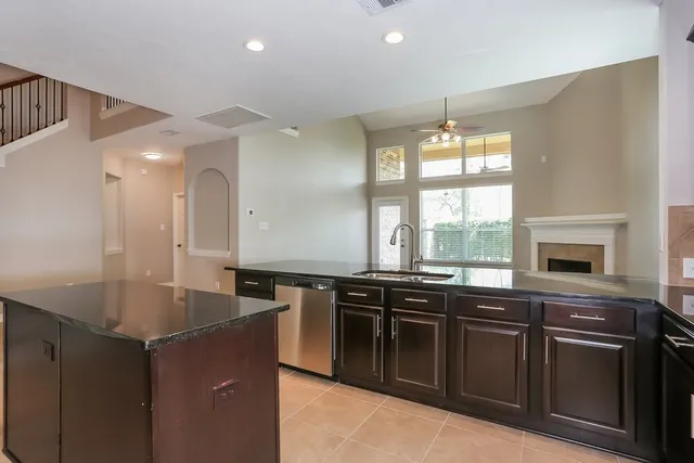 a kitchen with stainless steel appliances granite countertop a sink and a stove