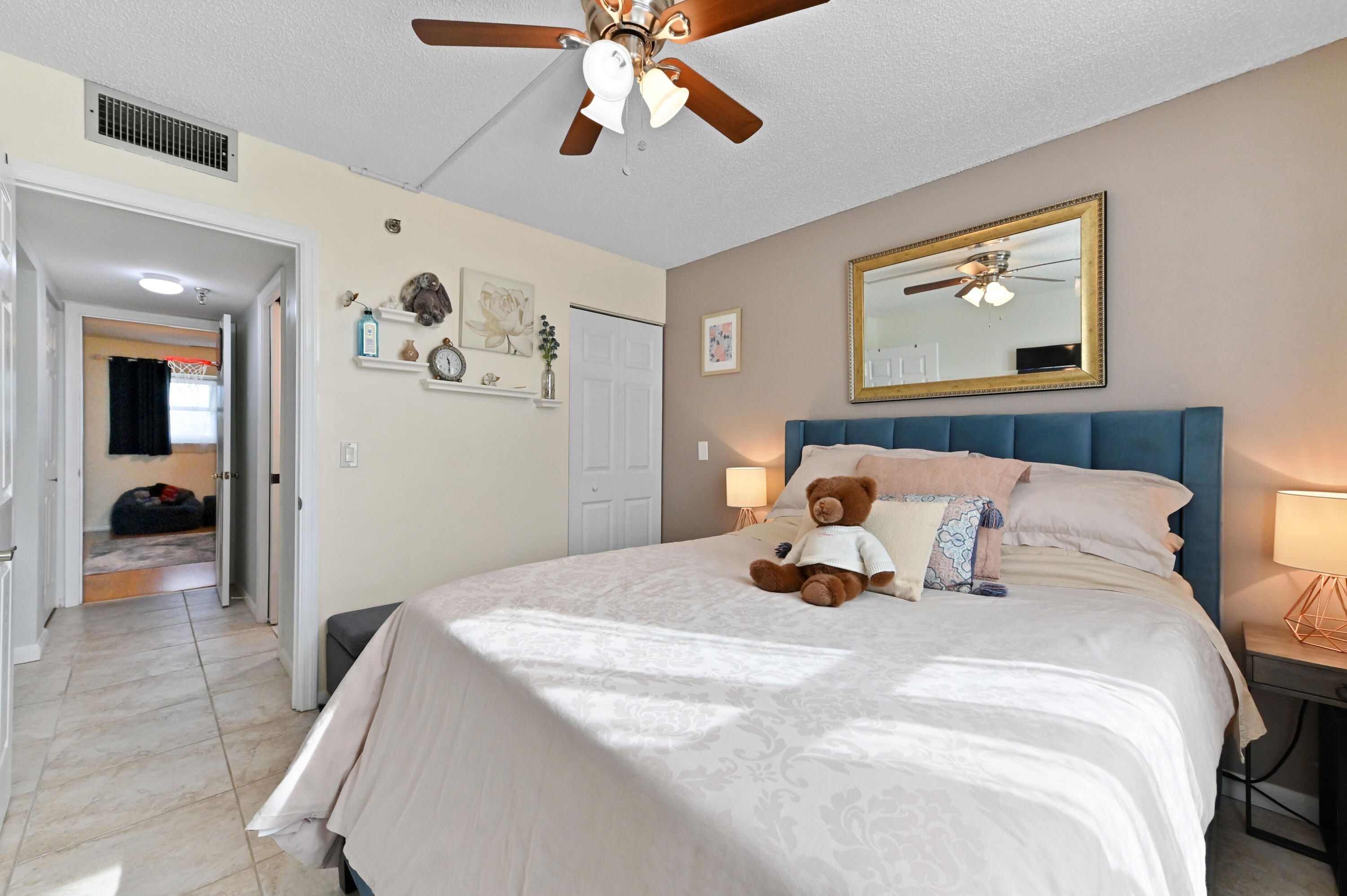 198 Northwest 67th Street, Unit 207 Boca Raton, FL 33487 - Photo 25 of 42 a bedroom with bed and a chandelier