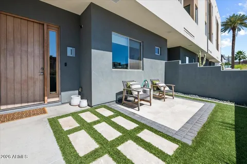 a view of a patio with table and chairs