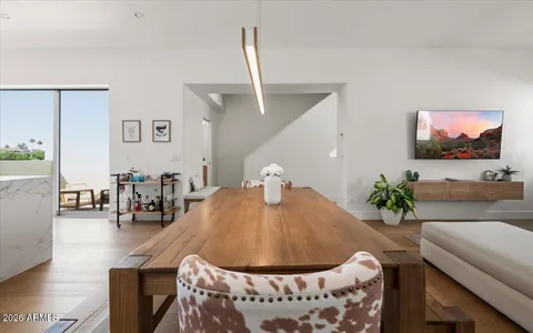 a living room with furniture potted plant and a window