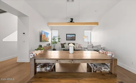 a living room with furniture a flat screen tv and kitchen view