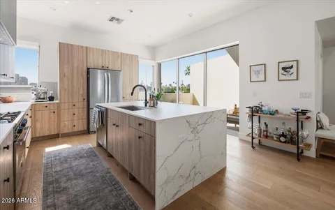 a kitchen with stainless steel appliances a sink stove and cabinets