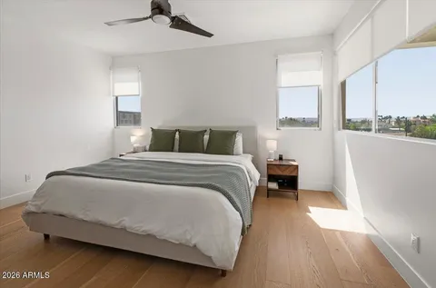 a bedroom with a bed and a flat screen tv