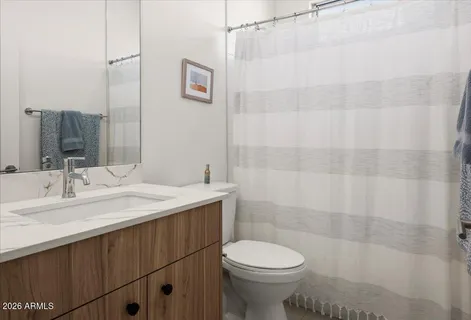 a bathroom with a double vanity sink a mirror and a shower