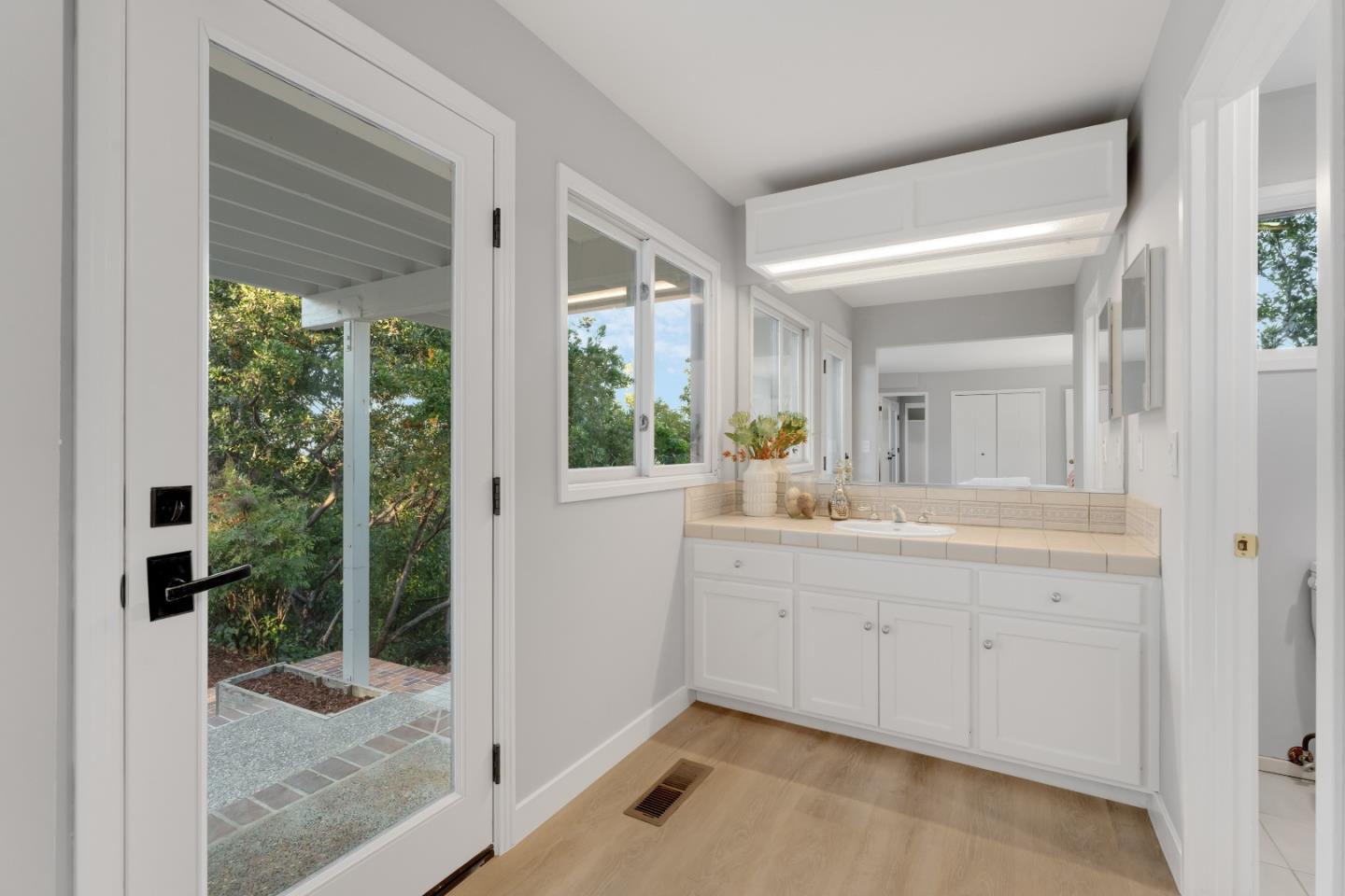 21221 Canyon View Drive Saratoga, CA 95070 - Photo 33 of 45 a bathroom with a granite countertop sink mirror and shower