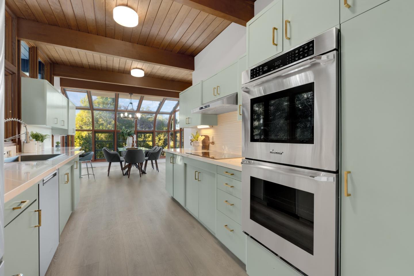21221 Canyon View Drive Saratoga, CA 95070 - Photo 7 of 45 a kitchen with stainless steel appliances white cabinets and a fireplace