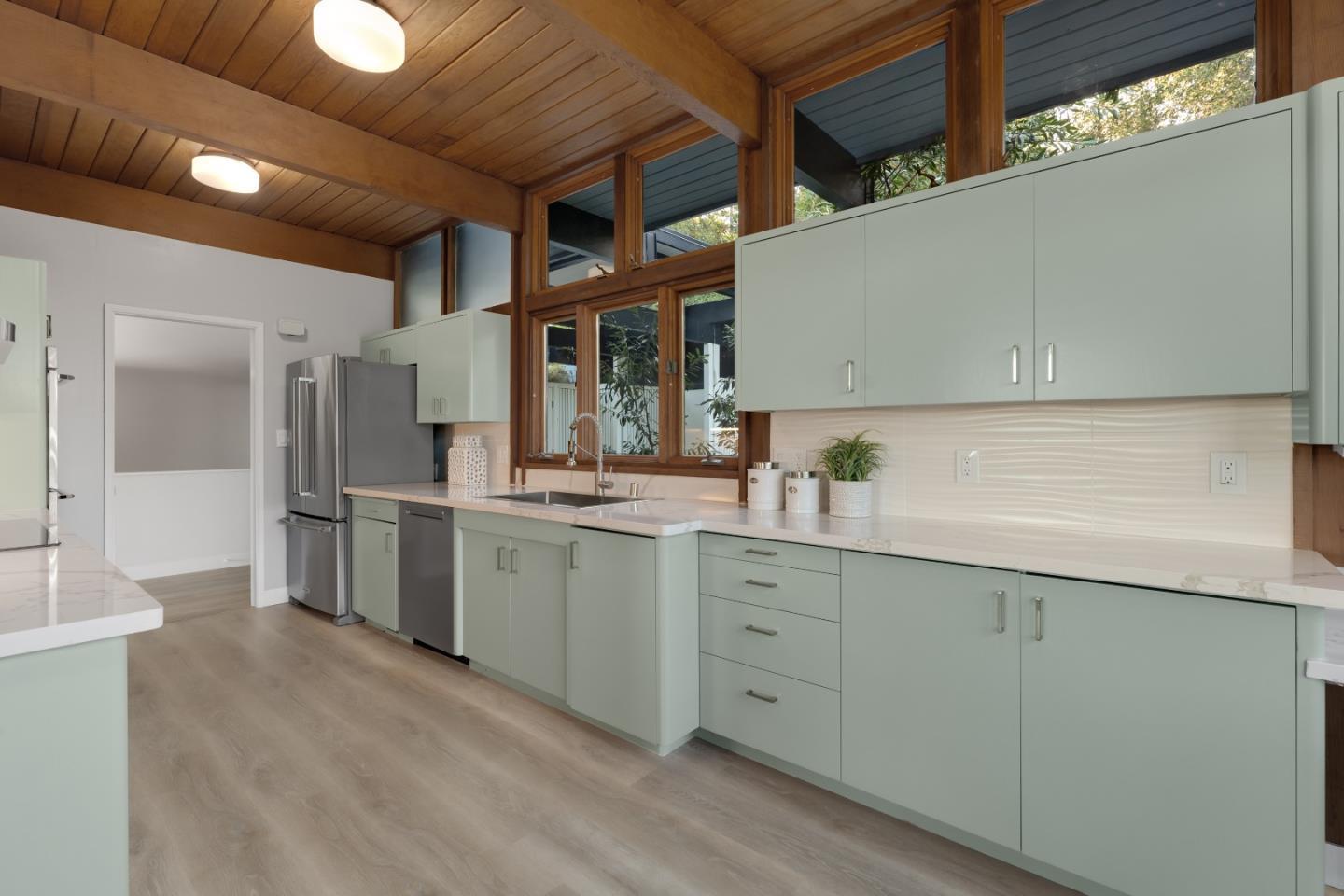 21221 Canyon View Drive Saratoga, CA 95070 - Photo 8 of 45 a kitchen with white cabinets and sink