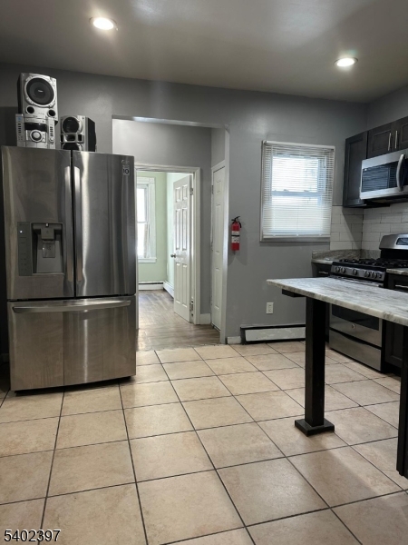 8 4th Street Passaic, NJ 07055 - Photo 4 of 10 a kitchen with stainless steel appliances granite countertop a refrigerator and a sink