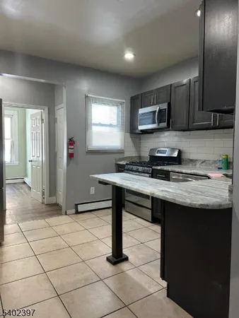 a kitchen with a sink cabinets and window