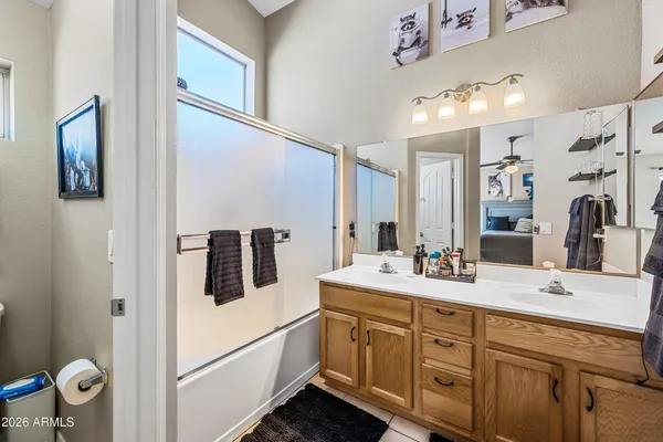 a bathroom with a sink vanity and mirror