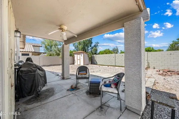 a view of a patio with a table and chairs