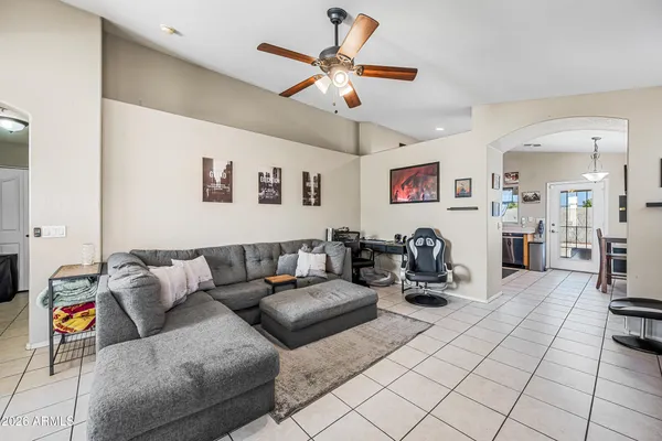 a living room with furniture and kitchen view