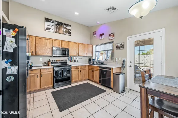 a kitchen with a stove top oven sink and cabinets