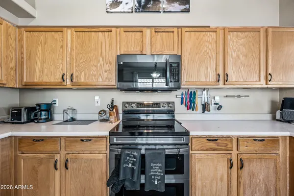 a kitchen with granite countertop a stove a sink and a microwave