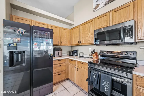 a kitchen with stainless steel appliances a stove microwave and a refrigerator