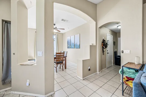 a view of room with furniture and a refrigerator