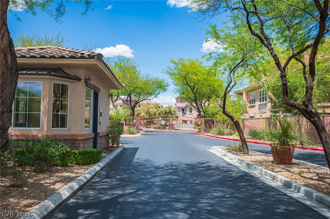 9916 Sable Point Street Las Vegas, NV 89178 - Photo 58 of 73 Secure community entrance with an inviting guardhouse and verdant landscaping.