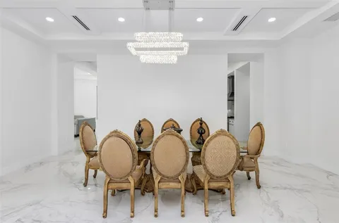 a large kitchen with stainless steel appliances kitchen island granite countertop a refrigerator and a sink