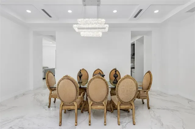 a large kitchen with stainless steel appliances kitchen island granite countertop a refrigerator and a sink