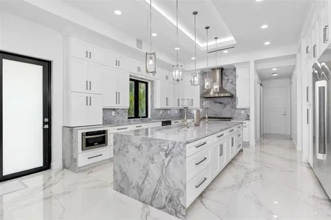 a bathroom with a granite countertop sink a toilet and shower