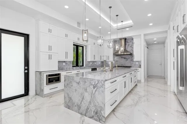 a bathroom with a granite countertop sink a toilet and shower