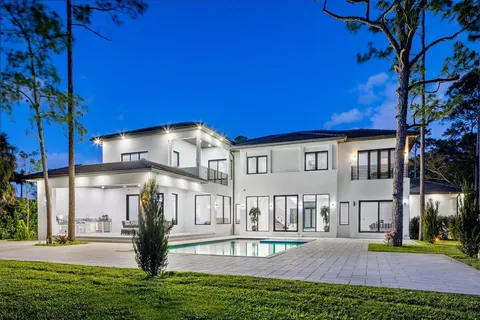 a view of a house with a yard and tree s