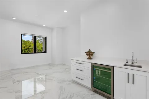 a bedroom with bed and large window