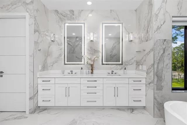 a kitchen with stainless steel appliances granite countertop a sink stove and cabinets