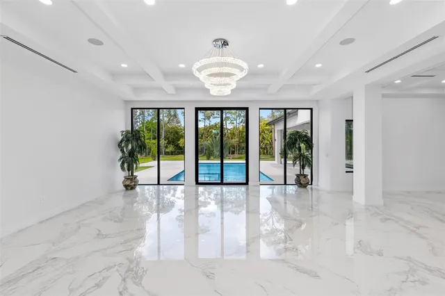 a large white kitchen with a white cabinets and sink
