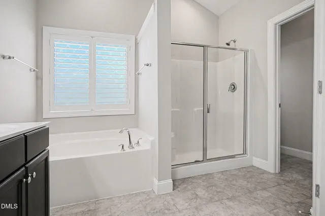 a bathroom with a bathtub and a shower