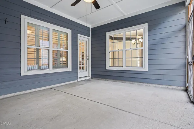a front view of a house with a yard and potted plants