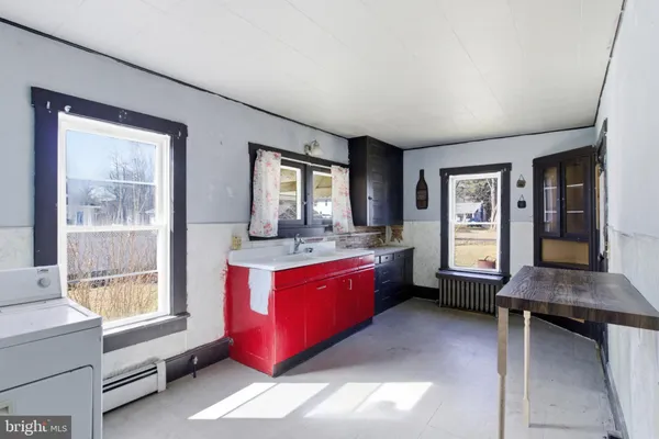 a large spacious bedroom with a large bed and windows