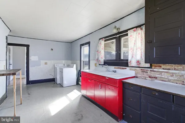 a kitchen with a sink stove and cabinets