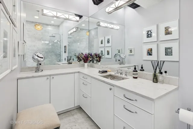 a bathroom with a sink double vanity and a mirror